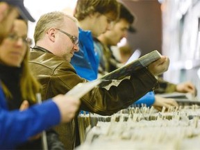 Music fans search through the records at Vertigo Records store on Rideau Street during the Record Store Day.