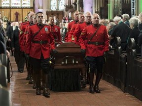 Members of the RCMP carry the casket of the late Jim Flaherty following his state funeral in Toronto on Wednesday, April 16, 2014. THE CANADIAN PRESS/Frank Gunn