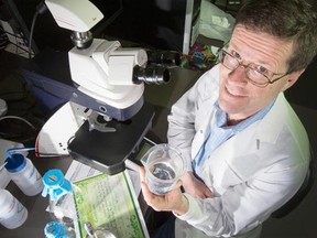 Reporter Tom Spears poses as a scientist for illustration on story about dubious scientific journals that publish anything for a price. Photo taken on April 17, 2014. (Photo by Wayne Cuddington/ Ottawa Citizen)
