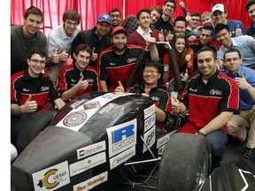 Fourth-year engineering student, Kenneth Chow, sits behind the wheel of a small-scale F1 race car, designed and built by the Raven's Racing Team, pictured, at Carleton University.