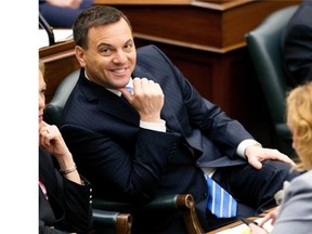 Ontario PC leader Tim Hudak smiles from his seat during question period in the Ontario Legislature n Toronto on Tuesday April 8, 2014. THE CANADIAN PRESS/Frank Gunn