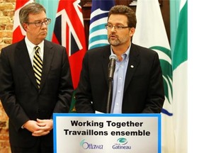 Ottawa Mayor Jim Watson (L) and Gatineau Mayor Maxime Pedneaud-Jobin make a “significant announcement” after their first formal meeting in Ottawa, January 29, 2014. Photo by Jean Levac/Ottawa Citizen