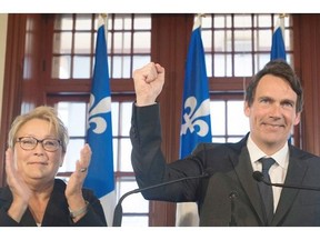 Parti Quebecois leader Pauline Marois looks on as Pierre Karl Peladeau gestures during a press in Saint Jerome, Que., Sunday, March 9, 2014.THE CANADIAN PRESS/Graham Hughes