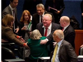 Toronto Mayor Rob Ford runs over a fellow councillor while running to his brother, Councillor Doug Ford. In spite of the obvious distractions, the huge city has managed to trim its spending.