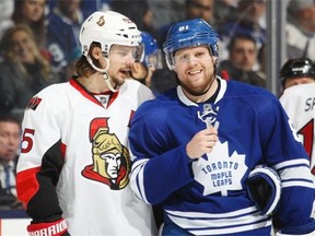 Phil Kessel #81 of the Toronto Maple Leafs listens to some chatter from Erik Karlsson #65 of the Ottawa Senators during an NHL game at the Air Canada Centre on February 1, 2014 in Toronto, Ontario, Canada. The Maple Leafs defeated the Senators 6-3.