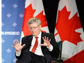 Primer Minister Stephen Harper gestures as he speaks at a business round table in Kitchener, Ont., on Friday, April 25, 2014. THE CANADIAN PRESS/Nathan Denette