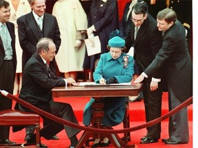 The Queen signs Canada's constitutional proclamation in Ottawa on April 17, 1982 as Prime Minister Pierre Trudeau looks on. The Supreme Court of Canada says it will investigate allegations that some of its members intervened in the repatriation of the Constitution. THE CANADIAN PRESS/Ron Poling