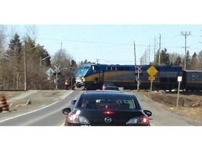 As a Via Rail train passed through Barrhaven Wednesday afternoon, the railway’s protective gates were not lowered. A worker dressed in orange watched the intersection.