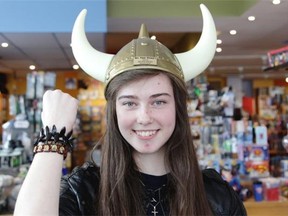 Sarah Gordon, 17, wearing her Band of Dark Souls bracelet, proudly shows off the Helmet of Glory she won at Mrs. Tiggy Winkle's Saturday, beating 20 opponents to claim the 2014 Munchkin Master title.
