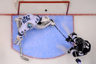 Los Angeles Kings right wing Justin Williams, right, scores San Jose Sharks goalie Alex Stalock looks on during the first period in Game 6 of an NHL hockey first-round playoff series, Monday, April 28, 2014, in Los Angeles. (AP Photo)