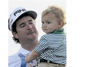 Bubba Watson walks with his son Caleb after winning the 2014 Masters Tournament by a threestroke margin on Sunday.