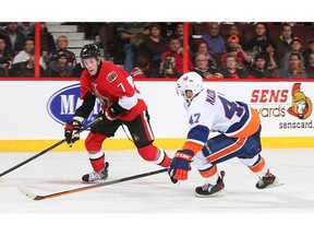 Kyle Turris #7 of the Ottawa Senators positions himself for a shot against Andrew MacDonald #47 of the New York Islanders at Canadian Tire Centre on November 1, 2013 in Ottawa, Ontario, Canada.