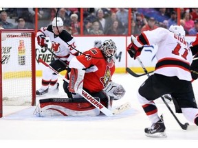 Stephen Gionta (R) of the New Jersey Devils shoots on Robin Lehner of the Ottawa Senators during second period of NHL action at Canadian Tire Centre in Ottawa, April 10, 2014.