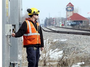 Staff from Railterm, on contract from VIA, check the track signals at Fallowfield Road in Barrhaven Monday, April 7.