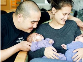 Stephanie and Ata Iemsisanith snuggle with their baby girls, Mackenzie, left, and Mackayla, now four months old, at Children’s Hospital of Eastern Ontario. The twins were born three months’ premature.