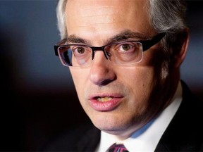 Treasury Board President Tony Clement speaks with the media about negotiations with the public service, Wednesday March 26, 2014 in Ottawa.