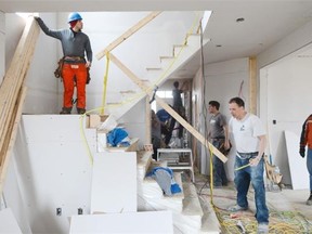 Workers are busy at the site of Blitz Build project on Saturday, April 5, 2014.