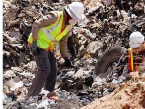 Workers sift through trash in search Saturday for decades-old E.T. the Extra-Terrestrial Atari game cartridges in Alamogordo, New Mexico.