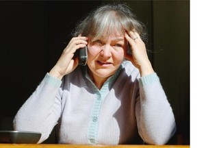 Yvonne Stefancic breaks down in tears Wednesday, the victim of a telemarketer’s use of her home phone number on call display. She has received hundreds of telephone calls from people who believed she was behind the sales pitch calls.