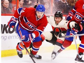 Zack Smith of the Ottawa Senators is sandwiched between Alexei Emelin (L) and Andrei Markov of the Montreal Canadiens during the first period of NHL action at Canadian Tire Centre in Ottawa, April 04, 2014.