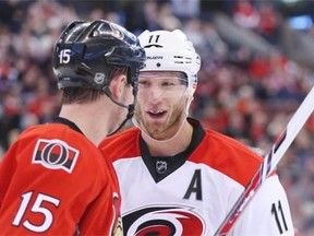 Zack Smith of the Ottawa Senators has a war of words with Jordan Staal of the Carolina Hurricanes during second period of NHL action at Canadian Tire Centre in Ottawa, March 31, 2014.