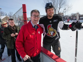 OTTAWA, ONTARIO: February 20, 2014 -- Marc Methot (R) stops to greet Mayor Jim Watson as the Ottawa Senators practice on an outdoor rink at Jules Morin Park on York St. (Photo by Wayne Cuddington/ Ottawa Citizen) 116188