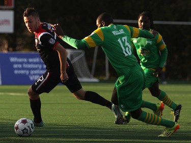 Ottawa Fury FC's Carl Haworth avoids Tampa Bay Rowdies defenders during NASL action on Saturday, May 10, 2014 at Carleton University.