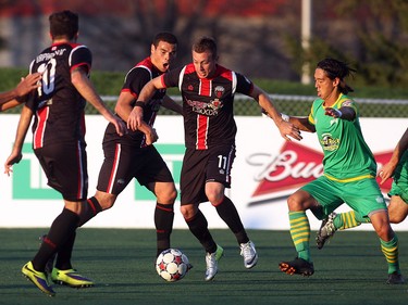 Ottawa Fury FC's Oliver Minatel avoids Tampa Bay Rowdies' Willie Hunt during NASL action on Saturday, May 10, 2014 at Carleton University.