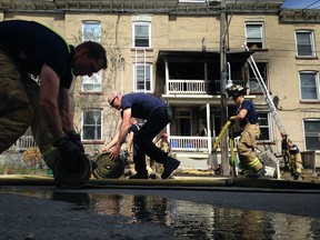 Ottawa firefighters respond to a blaze in an apartment building on Preston, Saturday, May 10, 2014. (Cole Burston/Ottawa Citizen)