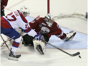 Curtis Lazar of the Edmonton Oil Kings goes  against Justin Nichols of the Guelph Storm during the second period during the 2014 Memorial Cup championship game at Budweiser Gardens on May 25, 2014 in London, Ont.