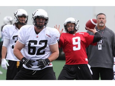 Nolan MacMillan, 62,  and Brandon Bialkowski,9, practise during the opening day of the Redblacks' rookie training camp on May 28, 2014.