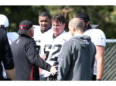 #62 Nolan MacMillan listens to his coach during the opening day for the RedBlacks rookies training camp, May 28, 2014.