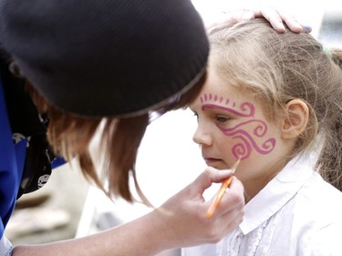 8 year old Mallory Jansen has her face painted at one of the artist booths set up at China Town Remixed. A variety of different artist took part in the 6th annual China Town Remixed which runs till June 17th in Ottawa.