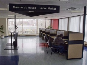 A man looks through jobs at a Resource Canada offices in Montreal April 9, 2009. THE CANADIAN PRESS/Ryan Remiorz