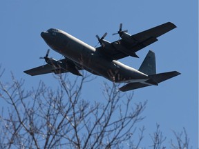 A Hercules aircraft passes overhead.