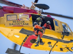 A search and rescue technician (SAR tech) performs a hoist sequence with a CH-146 Griffon helicopter during Tigerex 2014 at Mont Cascades Ski Resort in Cantley, Que. on Tuesday, May 6, 2014.