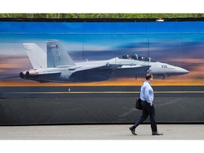 A visitor walks past the FA 18 Super Hornet display as the annual trade fair for military equipment known as CANSEC took place at the EY Centre near the airport.
