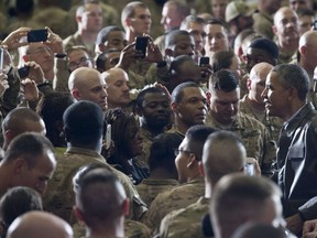 In this file photo from 2014, U.S. President Barack Obama greets U.S. troops at Bagram Air Field, north of Kabul. An attack Saturday killed four at the base.