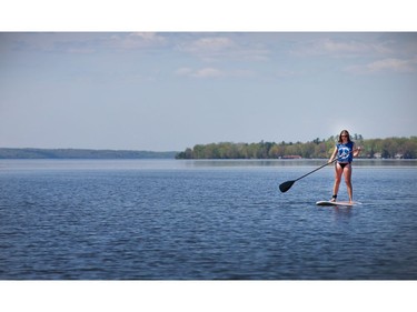 Amanda Havey tries out the stand up paddle boards available for rent from the city of Ottawa at Britannia Beach. Photo taken at 1:24 on May 20, 2014.