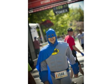 Batman who is really Hugo Breton finishes the marathon at Ottawa Race Weekend Sunday May 25, 2014.