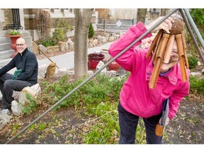 Bonnie Mabee, centre, will lead a Jane’s Walk around Centretown this weekend, focusing on the green spaces, such as this one under the care of Bill Brown, left, at Arlington and Metcalfe.