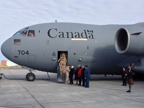 The last of Canada's troops to return from Afghanistan are greeted by dignitaries including Gov. Gen. David Johnston and Prime Minister Stephen Harper, as they arrive March 18, 2014 at the Ottawa International Airport in Ottawa, Ontario, Canada.