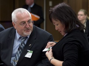 Carol Todd (right), the mother of Amanda Todd, speaks with Allan Hubley, the father of Jamie Hubley, as they wait to appear before the Commons justice committee discusses Bill C-13, Protecting Canadians from Online Crime Act Tuesday, May 13, 2014 in Ottawa.
