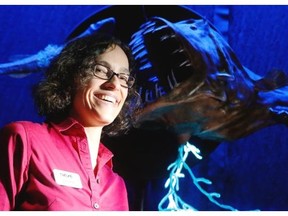 Caroline Lanthier, the project manager of the show, poses in front of the female angler fish, whose bioluminescence attracts mates and food.
