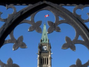 The Peace Tower is shown through the gates of Parliament Hill in Ottawa.