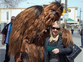 Chewbacca poses with Leslie Latham who was passing by as Ottawa Comiccon, which begins Friday at the EY Centre, held a press conference at Brother's Beer Bistro in the Byward Market. Photo taken on May 8, 2014.