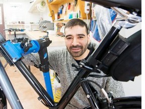 Claudio Wensel works in his home-based business called Pedal Easy in Ottawa on Thursday, April 10, 2014. He designs lightweight electric bikes in his garage.