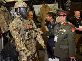 This file photo from 2014 shows Colonel Tawari M. Alfadly of Kuwait checking out some protective gear at the CANSEC military equipment trade fair in Ottawa.