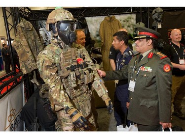 Colonel Tawari M. Alfadly of Kuwait checks out some protective gear as the annual trade fair for military equipment known as CANSEC took place at the EY Centre near the airport.