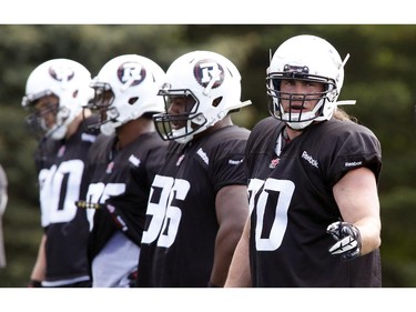 Connor Williams (R) gives instructions at the CFL Ottawa Redblacks rookie camp at Keith Harris Stadium in Ottawa on Friday May 30, 2014.